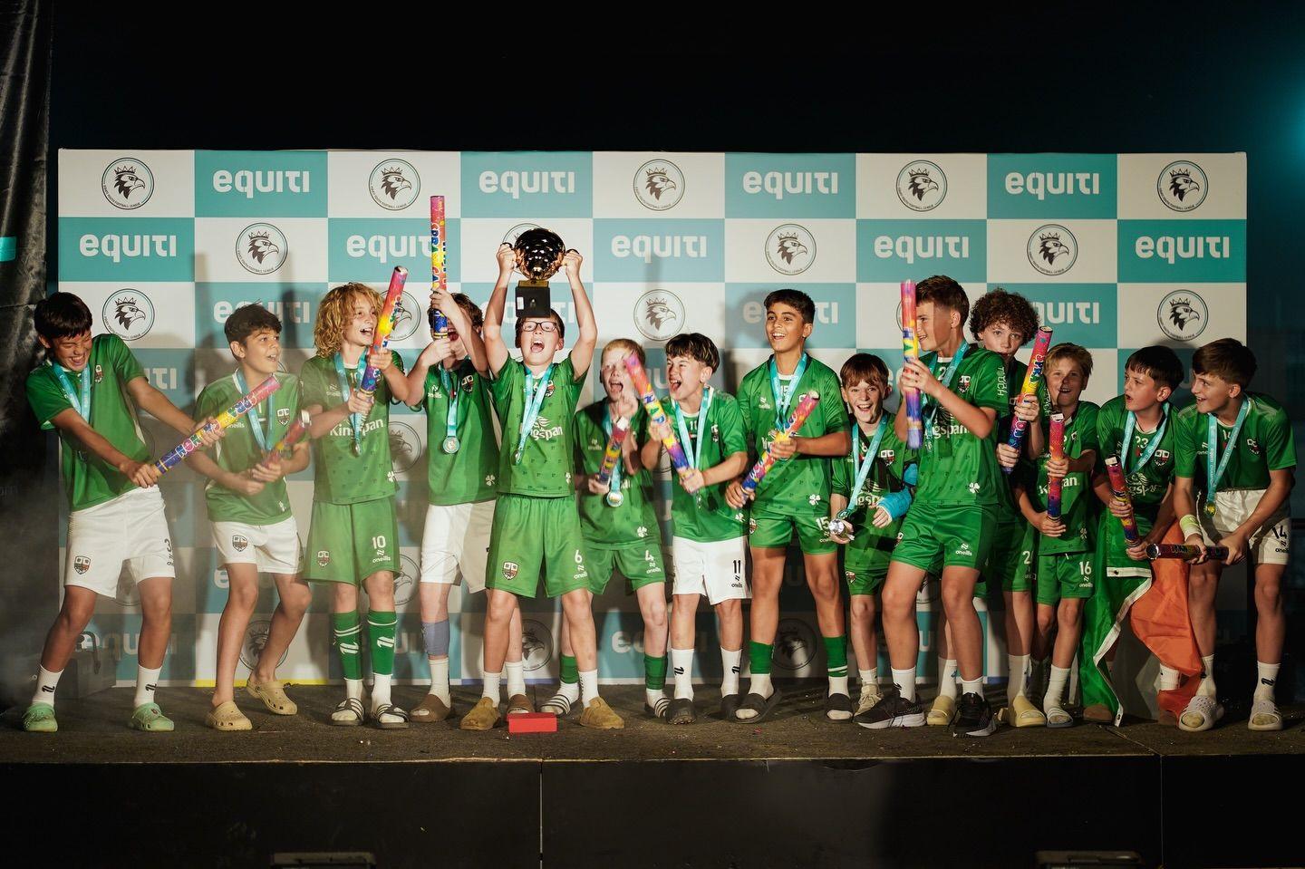 An EYFL team celebrates with the trophy on the Equiti stage